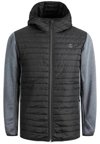 Black padded jacket with a zip closure and hood. Gray fabric sleeves. Textured panels on the body. Features logo on the chest.