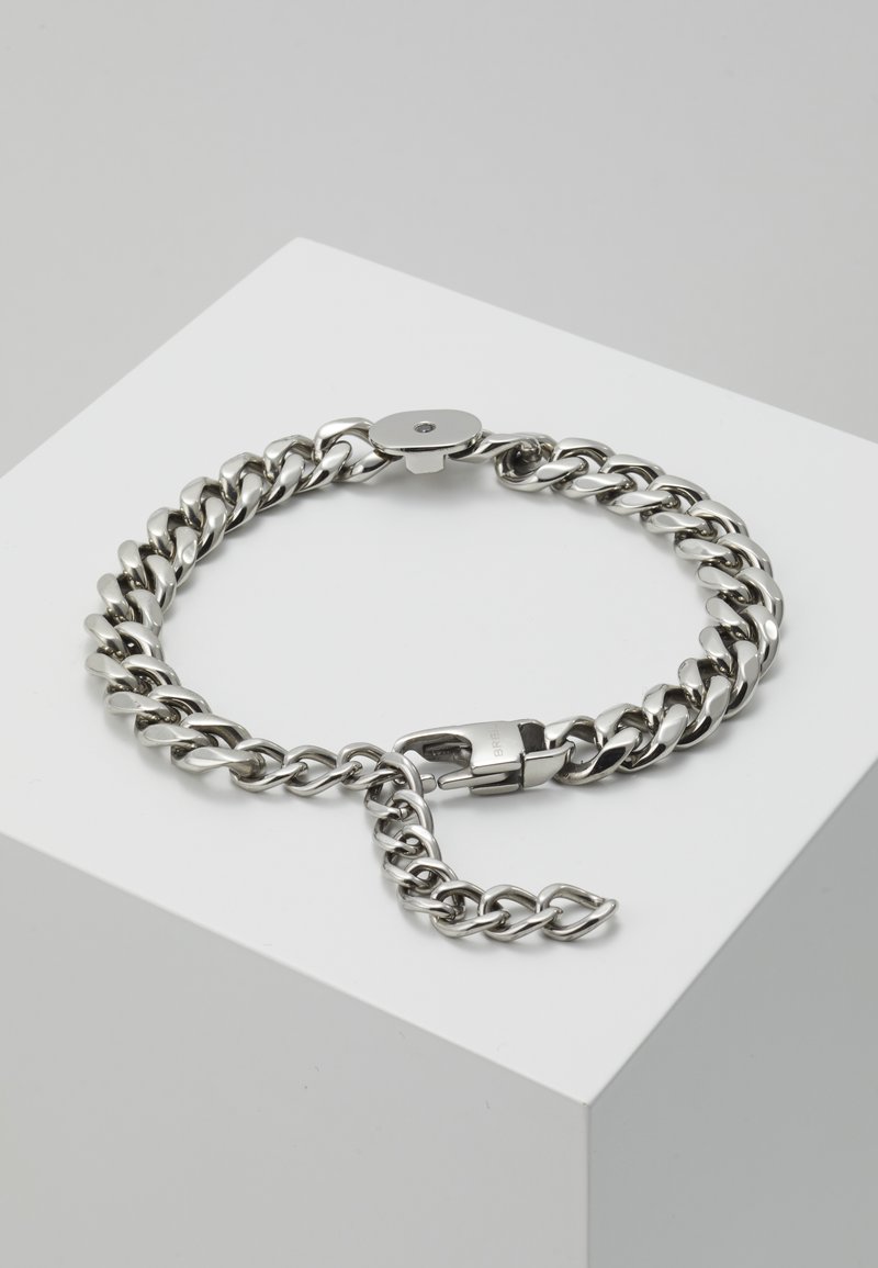 Silberne Kettenarmband mit dicken, ineinandergreifenden Gliedern, glatter Oberfläche und einem Federverschluss mit einem kleinen dekorativen Akzent.