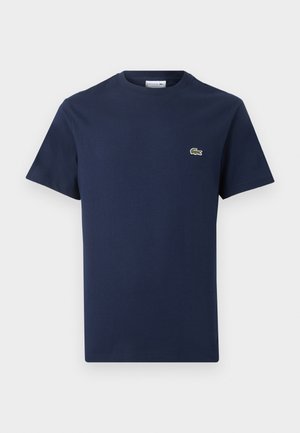 Μπλε ναυτικό κοντομάνικο βαμβακερό t-shirt με στρογγυλή λαιμόκοψη και μικρό πράσινο λογότυπο κροκοδείλου στο αριστερό στήθος.