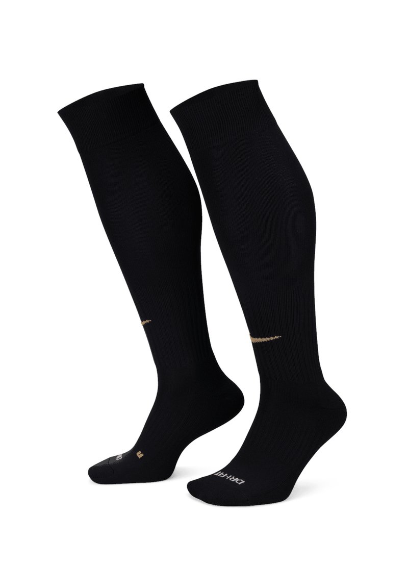 Calze nere fino al ginocchio con texture a coste, dotate di un dettaglio con logo dorato sul lato e aree rinforzate nel tallone e nelle punte.