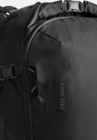 Schwarzer Rucksack aus strukturiertem Material, mit verstellbaren Trägern, seitlicher Tasche und einem auffälligen Logo mit der Aufschrift "FREE RIDER 28." Langlebiges Design.