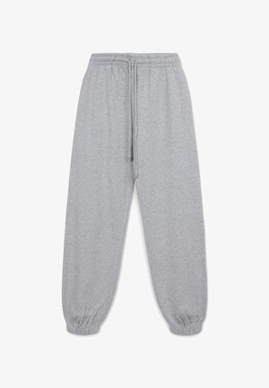 Graue Jogginghose aus weichem Material, mit einem elastischen Bund und Kordelzug, schmal zulaufenden Bündchen und einem lockeren Schnitt. Keine sichtbaren Muster.