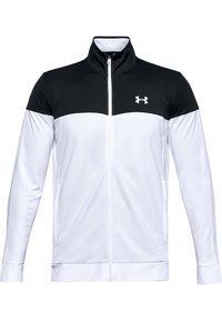 Vit idrottsjacka med svart övre del, hög krage, hel dragkedja och Under Armour-logotyp. Har slät tyg och figurnära design.