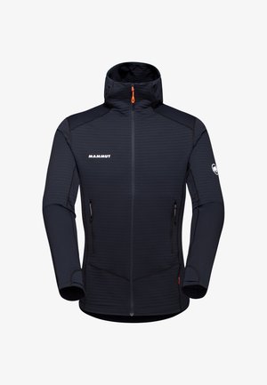 Marineblaue Mammut-Jacke mit hohem Kragen, Reißverschluss vorne und zwei seitlichen Taschen. Sie verfügt über einen strukturierten Stoff und kontrastierende schwarze Nähte.