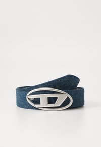 Denim belt in dark blue with a silver oval buckle featuring a cut-out design. The material has a textured finish.