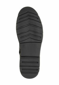 Suela de zapato de goma negra con un patrón de huella en zigzag. Presenta una superficie texturizada y áreas de agarre circulares. Talla marcada como 37.