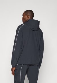 Under Armour CHALLENGER WARMUP JACKET - Outdoor jacket - black/white
