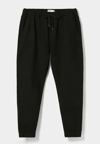 Pantalon de jogging noir en tissu doux, avec une taille élastique à cordon de serrage, des poches latérales et des jambes fuselées avec des poignets élastiques.
