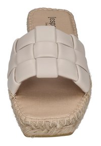 Woven beige synthetic slide sandal with a braided jute sole and beige footbed, featuring a wide strap design and flat, open toe.