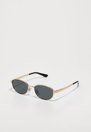 Óculos de sol de metal dourado com lentes ovais cinzentas, hastes finas e pontas em plástico preto. Apresenta logotipo na armação e suportes para o nariz ajustáveis.
