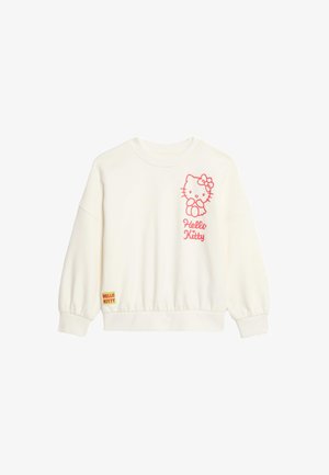 Cream-colored sweatshirt made of soft fabric, featuring a pink Hello Kitty graphic on the chest and a small branded tag on the hem.