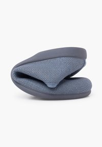 Zapatilla de textil suave en color azul, con un diseño plegable, que cuenta con una suela de goma y una superficie texturizada para mayor agarre y comodidad.