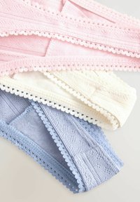 Pastel-colored lace trim fabric strips in pink, cream, and light blue; textured material with scalloped edges and intricate patterns.