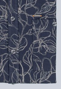 Short-sleeve shirt in navy fabric with a floral silver pattern. Features two buttons, a breast pocket, and a small tag with orange accent.