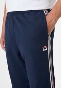 Fila BIELLA REGULAR TAPED - Verryttelyhousut - black iris