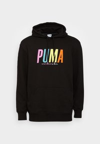Felpa nera con cappuccio e tasca a marsupio, con testo "PUMA" multicolore e "SPORTSWEAR by PUMA" in bianco sottostante. Cappuccio regolabile.