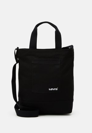 Saco de lona preto com alças curtas, correia de ombro ajustável, bolso frontal e logotipo Lev em branco. Design minimalista e durável.