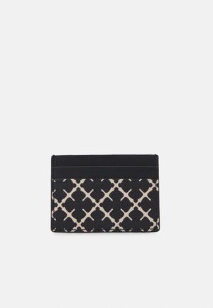 Cardholder made of textured leather. Features black and beige pattern with geometric motifs. Three card slots on top, sleek design.