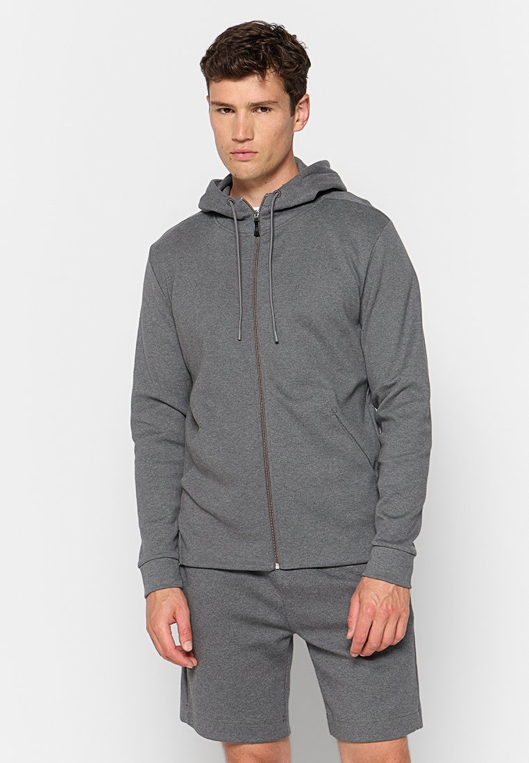 Grijze rits hoodie gemaakt van zacht, textuurstof. Beschikt over een capuchon met trekkoord, voorzakken en een ontspannen pasvorm, met bijpassende grijze shorts.