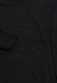 Cardigan nero lavorato a maglia con scollatura a V e polsini a costine. Tessuto morbido e testurizzato con un design semplice e senza hardware o motivi visibili.