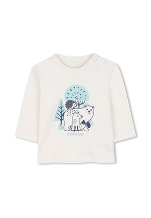 Cremfarbener Langarmshirt mit einem Grafikdruck von einem Bären, Fuchs und Igel vor blauen Bäumen. Mit Schulterknöpfen für ein einfaches Anziehen.