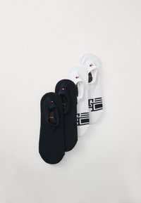 Two pairs of low-cut socks in navy and white. Navy pair is solid; white pair features a geometric black pattern and logo accent.