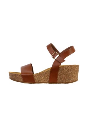 Sandale compensée marron avec plateforme en liège, large bride avant et bride de cheville ajustable avec boucle dorée.