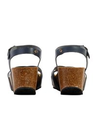 Sandales compensées en cuir noir avec une semelle en liège, dotées de deux sangles ajustables et d'une semelle extérieure en caoutchouc texturé noir.