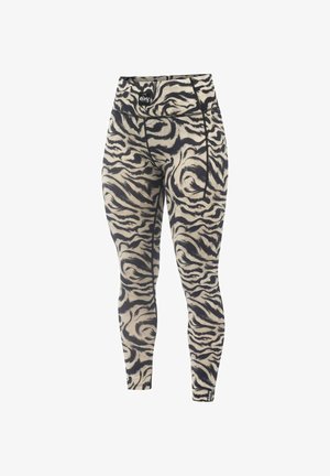 Strakke leggings van rekbare stof, met een beige achtergrond en een zwart tijgerstreep patroon, en een logo op de tailleband.