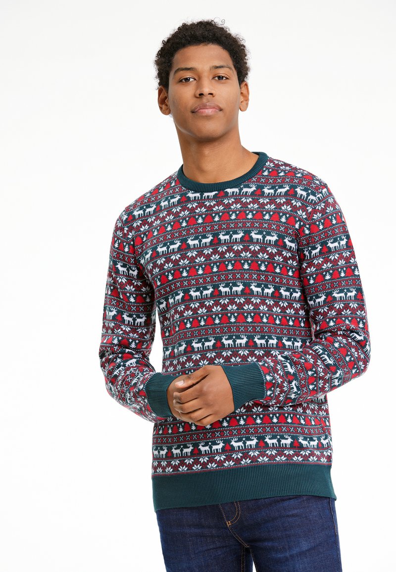 Sarkana un jūras zila svītrota džemperis ar ģeometriskiem motīviem, lūša attēliem un ribotām piedurknēm un apakšdaļu. Izgatavots no adīta auduma.