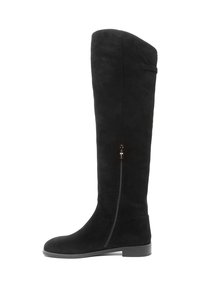 Bottes noires montantes au-dessus du genou en daim, dotées d'une fermeture éclair latérale, d'un bout arrondi et d'une semelle plate avec un petit talon.