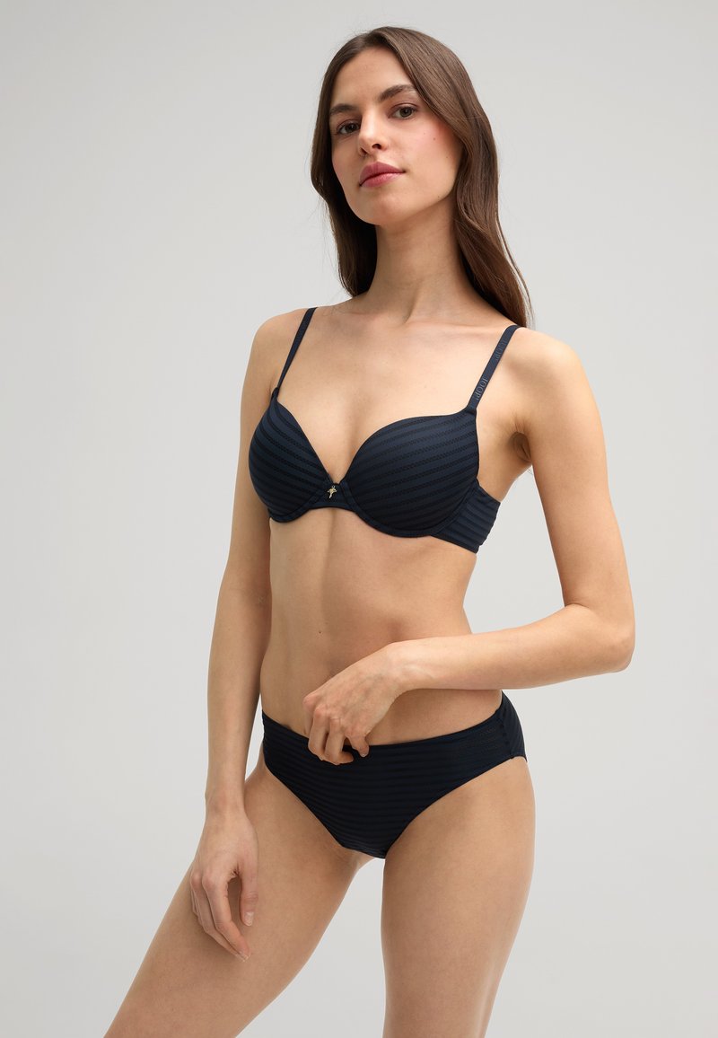 Black bikini with striped texture, featuring a padded bra with adjustable straps and a low-rise bottom. Gold accent detail on the bra.