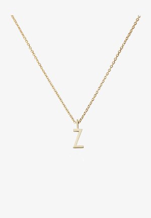 Collier de couleur or avec un design de chaîne et un pendentif stylisé en forme de lettre "Z". Le pendentif a une apparence lisse et minimaliste.