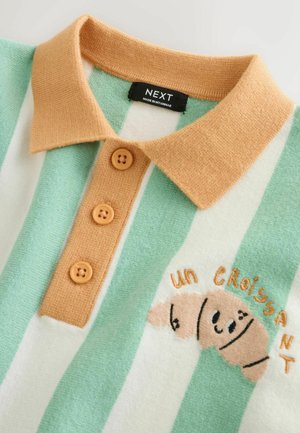 Grün-weiß gestreiftes Poloshirt mit einem orangefarbenen Kragen, drei braunen Knöpfen und einem bestickten Croissant-Design mit Text.