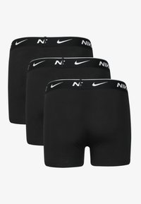 Black boxer briefs in a pack of three, featuring a black elastic waistband with white Nike logo and smooth, stretch fabric.