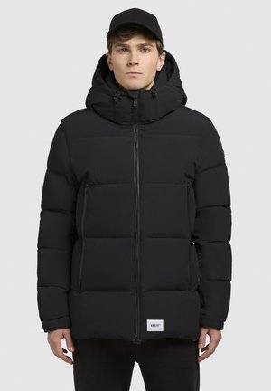 Black puffer jacket with a hood, featuring a zip front, rectangular quilted sections, and side zip pockets. Label at the hem.