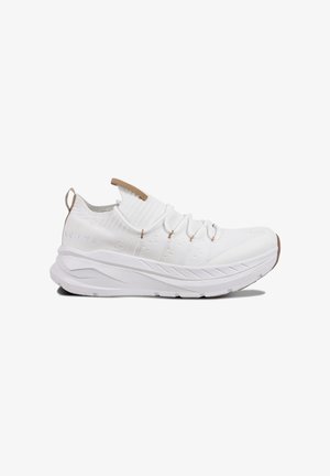 White athletic shoe with a knitted upper, elastic lacing, and a textured rubber sole. Features a brown pull tab and subtle branding.