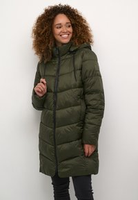 Green padded long coat with a zip closure, hood, adjustable drawstrings, and side pockets. Soft, smooth texture with horizontal stitching.