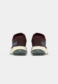 Maroon running shoes with a textured mesh upper, cushioned sole, and contrasting light blue logo. Rugged outsole for traction.