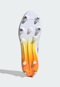 Valkoiset jalkapallokengät, joiden pohjassa on kuusi metallista piikkiä. Värigradientti vaihtelee valkoisesta kirkkaaseen oranssiin kantapäässä, ja pinta on teksturoitu pidon parantamiseksi.