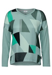 Długorękawowy top w serek w jasnym zielonym kolorze, z geometrycznymi kształtami w odcieniach teal, czerni i szarości. Gładka tekstura i luźny krój.