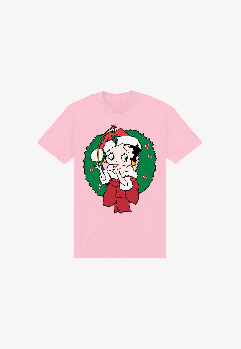 T-shirt rosa con un personaggio dei cartoni animati dai capelli neri e ricci, un cappello di Babbo Natale rosso, circondato da una ghirlanda verde con accenti rossi.