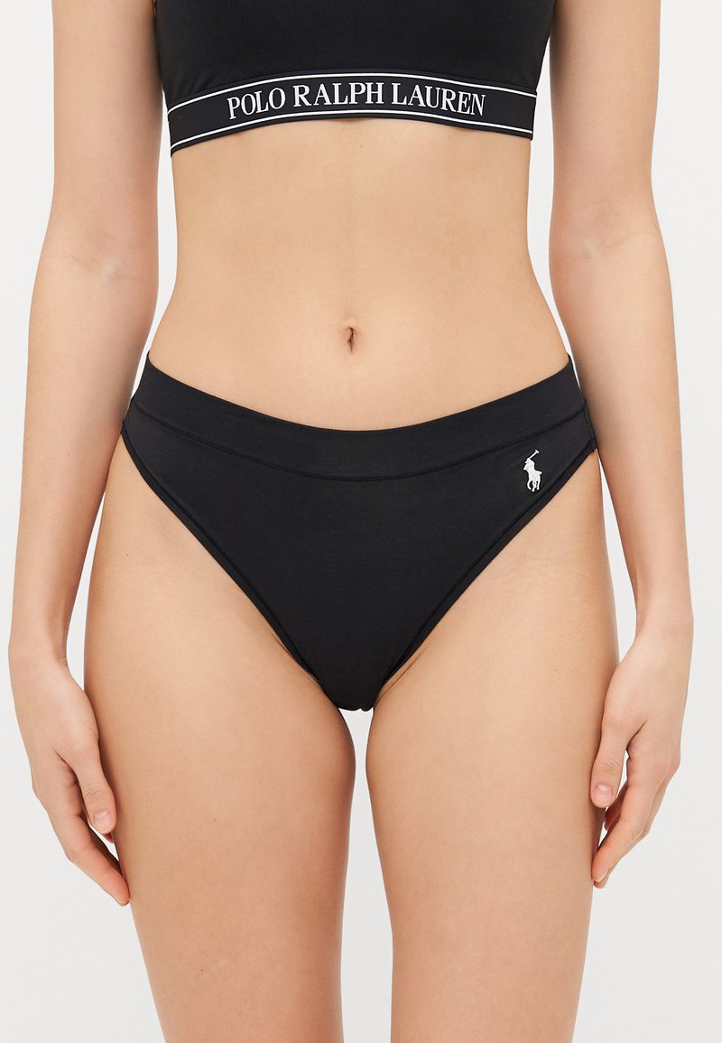 Black cotton bikini bottom with a smooth texture, high-cut design, and a subtle logo accent on the side.
