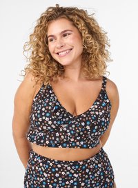 Black floral print bralette with ruffled hem and adjustable straps, featuring small pastel flowers in blue, pink, and white. Matching bottom.