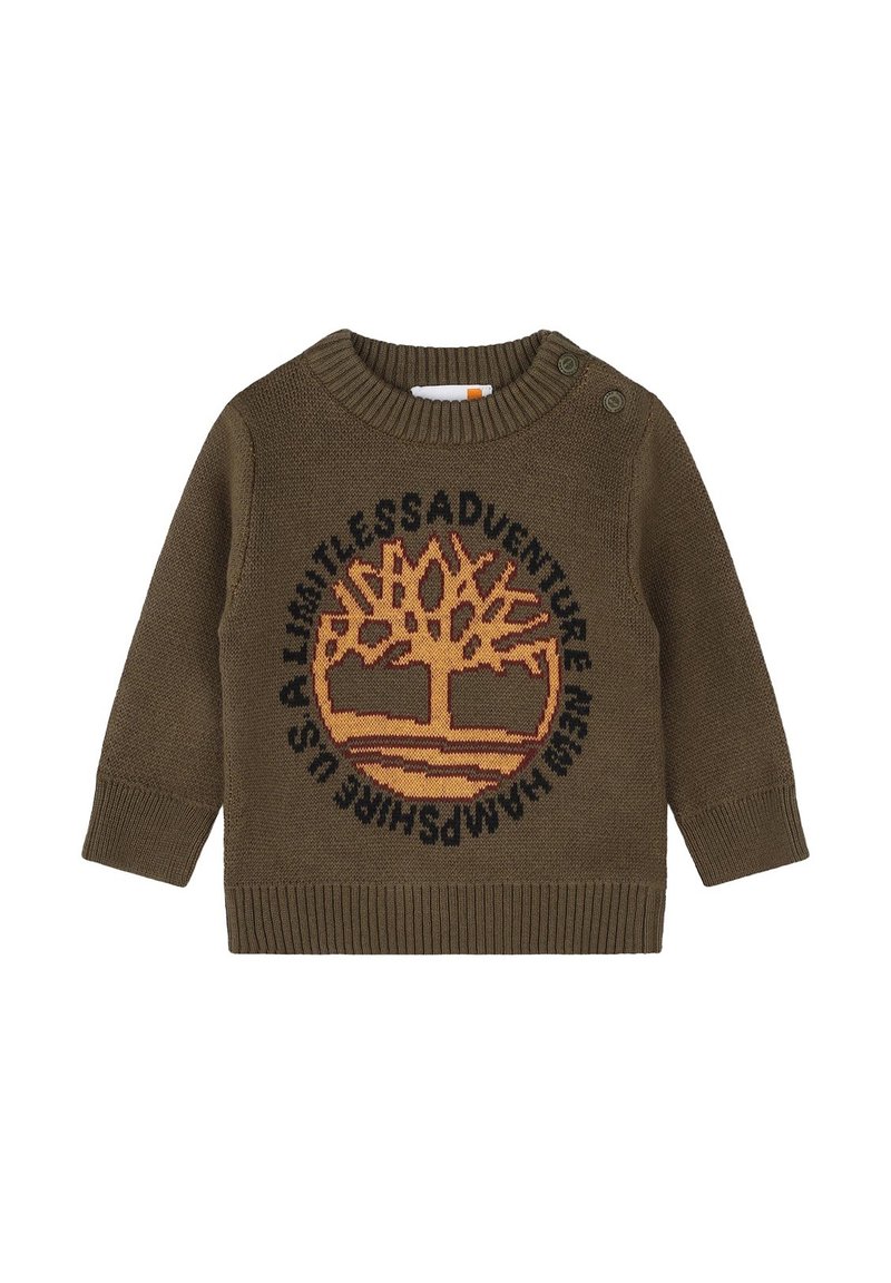 Maglione verde oliva lavorato a maglia con scollo rotondo e bottoni su una spalla. Presenta un design di un albero in arancione e testo nero attorno ad esso.