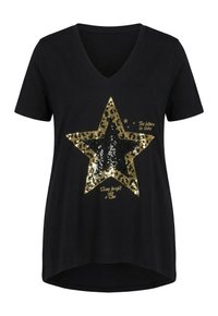 T-shirt noir à col en V avec une grande étoile en sequins dorés et noirs et un texte doré indiquant "Le futur est brillant" et "Brille comme une étoile".