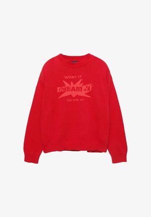 Rdeča pletena pulover s krožnim izrezom, ki ima dvignjeno grafično zasnovo z napisom "ŽELIŠ TO SANJAJ TO PRENESEJ TO" v svetlejšem odtenku.