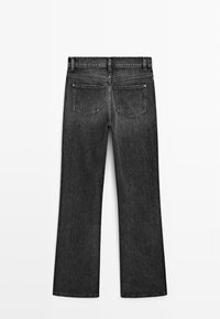 Black denim jeans with a straight leg design, featuring two back pockets and a clean finish. Material has a smooth, slightly distressed texture.