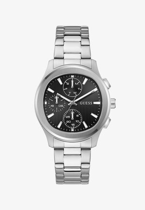 Srebrna kovinska zapestna ura s črnim številčnico, tremi podštevilčnicami za dan, 24-urno uro in sekunde ter srebrnimi označevalci ur, ki kažejo 10:10:20.