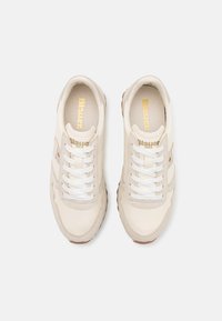 Beige sneakers with white laces, leather and fabric upper, textured rubber sole, featuring "Blauer" branding on the tongue and side.